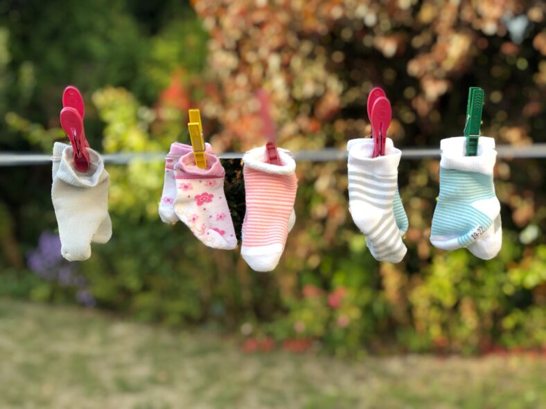 five pairs of socks pinned on clothesline